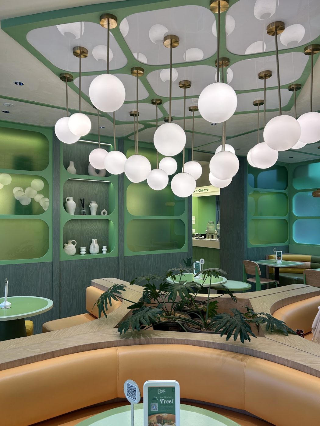 Cheevit Cheeva pastel green interior with globe lights